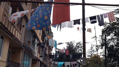 Clothes hanging and drying on a rope on a multi-story building in a poor Video stock 111368381