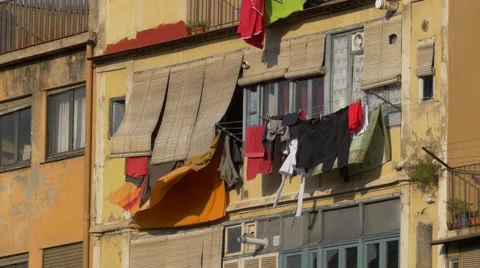 Clothes hanging on a colourful facade in the wind Stock Footage 67705250