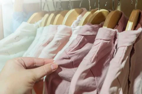 Clothes hanging on a hanger in a store Stock Photos