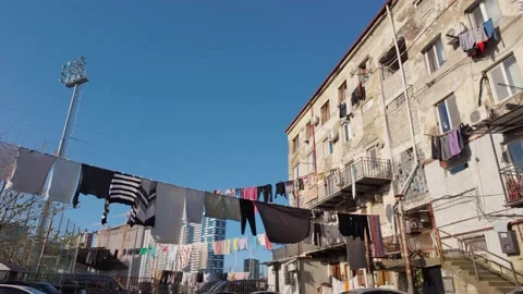 Clothes hanging on a line in a poor urban neighborhood 스톡 동영상 336640507