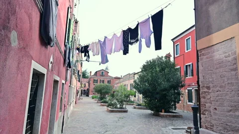 Clothes hanging out to dry in a small square in the village of Burano Stock Footage 232798808