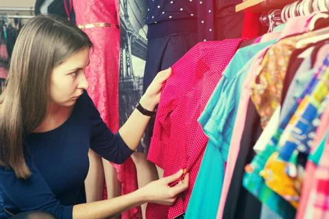 Clothes hanging on the rack in the store Stock Photos