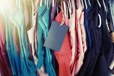 Clothes hanging on the rack in the store Stock Photos
