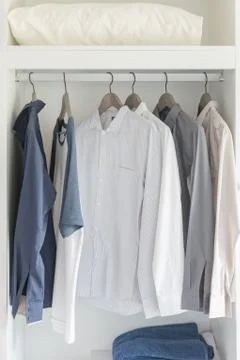 Clothes hanging on rail Stock Photos