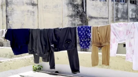Clothes Hanging on Rooftop to Dry in Intense Sunlight Showing Domestic Life Stock Footage 333609044