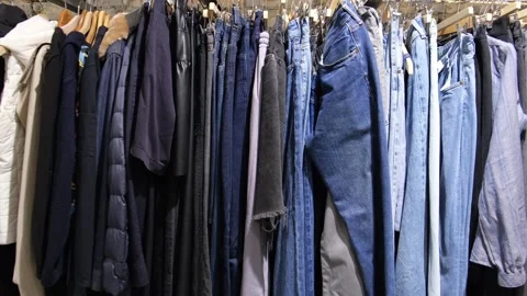 Clothes hanging in second hand store without people, concept of sustainable Stock Footage 310308024