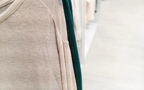 Clothes hanging on a store rack. Stock Photos