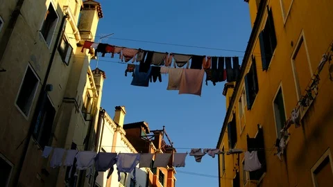 Clothes hanging on the wire to dry between two buildings in Venice Video stock 124749662