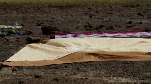 Clothes hung out to lay on the sand of the lake in Africa, Mali. Stock Footage 68370082