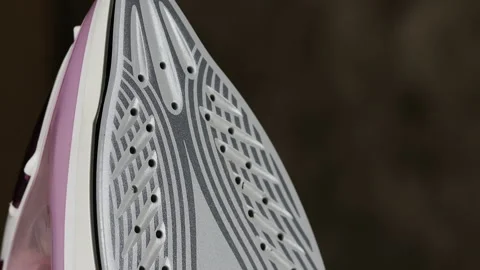 Clothes iron with steam close-up on a dark background Stock Footage 172109629