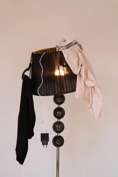 Clothes on the lamp, wardrobe Stock Photos