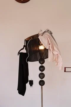 Clothes on the lamp, wardrobe Stock Photos
