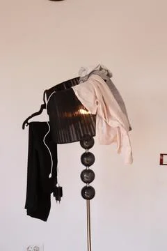 Clothes on the lamp, wardrobe Stock Photos
