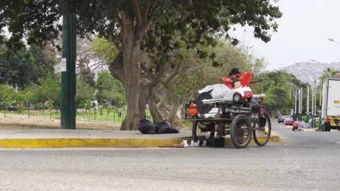 A clothes man arranging his things in his cart with a face mask Video stock 149906481