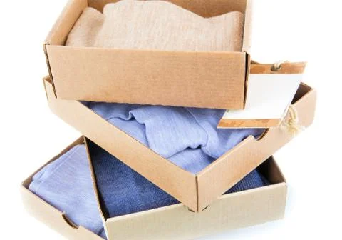 Clothes in open containers with card Stock Photos