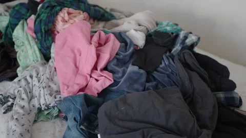 Clothes piling up on the bed needs sorting and organizing Stock Footage 329817085