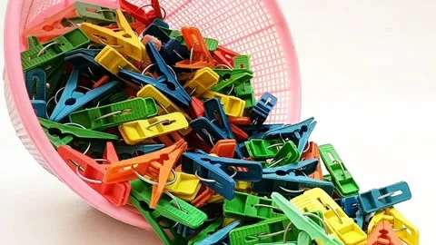 Clothes pins falling out of a basket moving on the white background,  Stock Footage 306340159