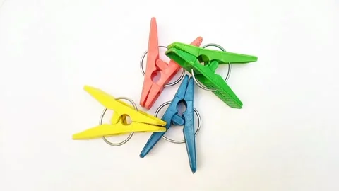 Clothes pins, four multi color plastic laundry clips or clothes pegs for house Video stock 305894483