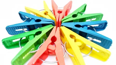 Clothes pins, multi color plastic laundry clips or clothes pegs in a circle Video stock 305894484