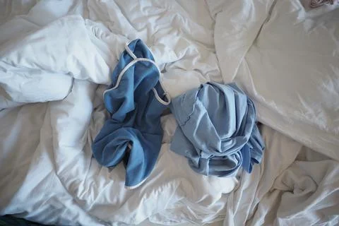 Clothes placed on a messy bed 스톡 사진