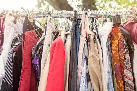 Clothes on a rack on a flea market Stock Photos