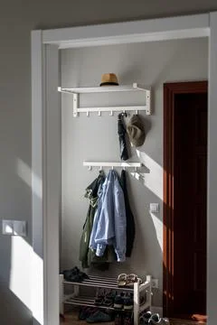 Clothes on rack in hallway Fotos Stock