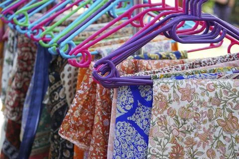 Clothes rack with a selection floral pattern clothing on colorful hangers 스톡 사진