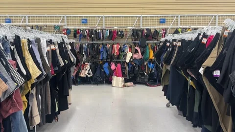 Clothes racks in a Thrift store displayed in rows Stock Footage 345966655