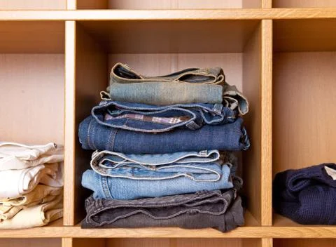 Clothes on regiments in a wardrobe Stock Photos