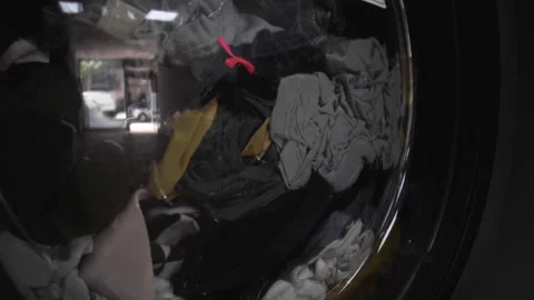 Clothes Spinning Inside A Front Load Washing Machine In A Laundry Shop - Stock Footage 135037567