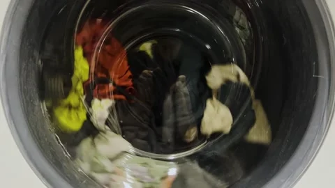 Clothes spinning in the washing machine. Clothes are washed in a washing machine Stock Footage 274654660