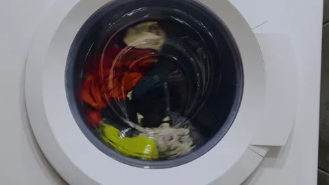 Clothes spinning in the washing machine. Clothes are washed in a washing machine Stock Footage 275242532