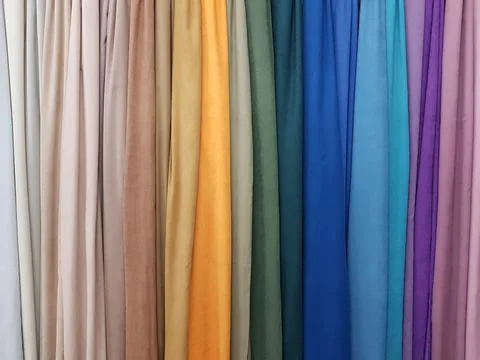 Clothes stack. Bright colourful rainbow fabric Stock Photos
