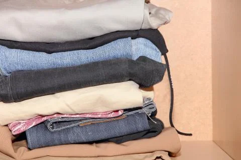 Clothes stack in wardrobe. Stock Photos
