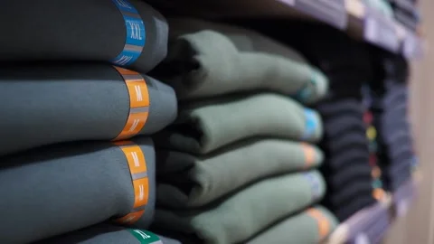 Clothes stacked on shelves in a store Stock Footage 324834867
