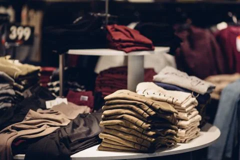 Clothes store. Stack of men clothes in men's clothing store Stock Photos