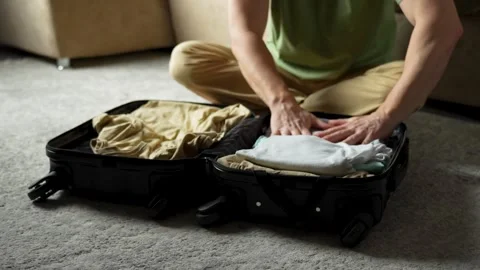 Clothes, suitcase and man packing for holiday and travel Stock Footage 272586403