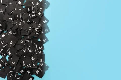 Clothes tags with different sizes. Top view. Flat lay. Clothing size S, M. Place Stock Photos