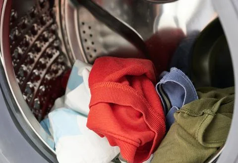 Clothes in the washing machine, close-up, selective focus Stock Photos
