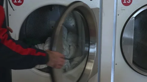 Clothes in the washing machine in the public laundry Stock Footage 221645250
