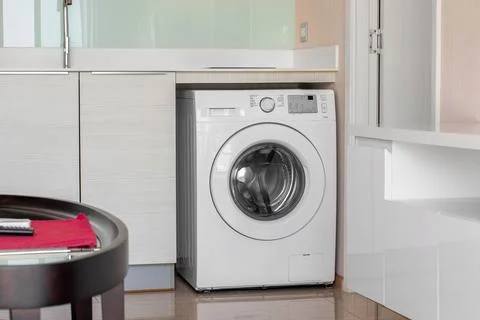 Clothes washing machine in room interior Stock Photos