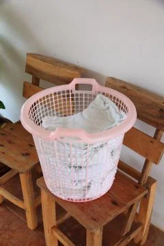 Clothes in white plastic basket. Foto stock