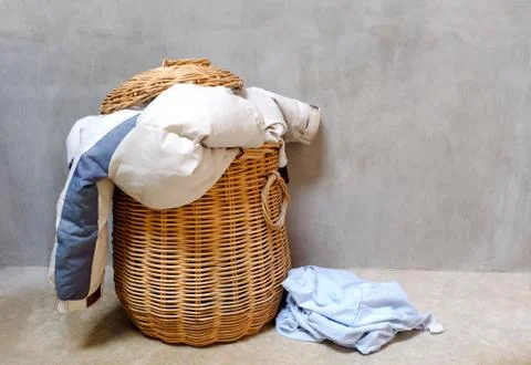 Clothes in wicker basket Stock Photos