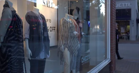 Clothes at window display during dusk Stock Footage 84515712