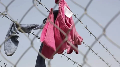Clothes on Wire Fence Stock Footage 64847215