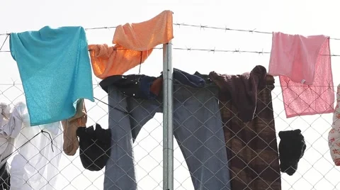 Clothes on Wire Fence Stock Footage 64847378