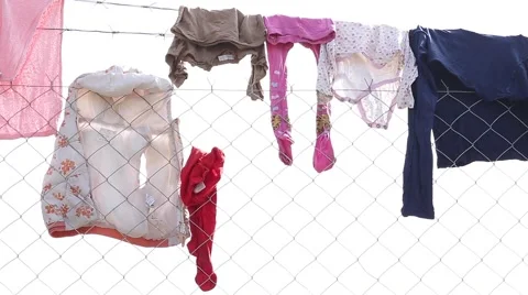 Clothes on Wire Fence Stock Footage 64847383