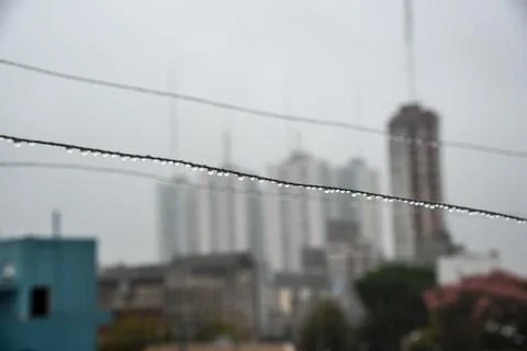 Clothesline cable full of small drops on a rainy day with a selective focus Stock Photos