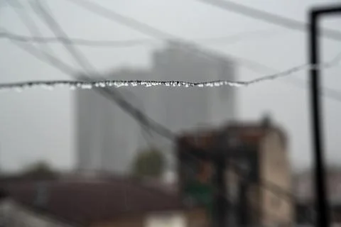 Clothesline cable full of small drops on a rainy day with a selective focus Stock Photos