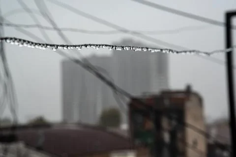 Clothesline cable full of small drops on a rainy day with a selective focus Stock Photos